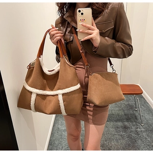Detail of suede tote and crossbody bag set with white faux shearling trim and brown strap