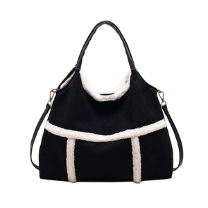 Black faux suede tote bag with white faux fur trim and gold hardware accents
