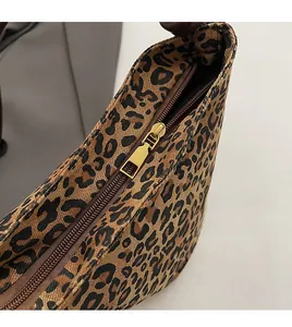 Close-up of premium leopard print canvas bag featuring smooth golden metal zipper detail