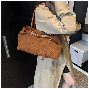 Close-up of caramel brown matte suede tote bag with contrast leather handles and strap