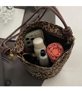 Spacious interior of leopard print bucket bag showing phone and daily essentials