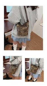 Detail of leopard print drawstring bucket bag with golden rose charm and brown strap