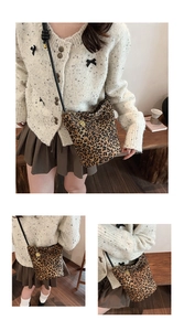 Detail of leopard print canvas bucket bag showing textured fabric and gold hardware buckle