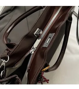Detailed macro of smooth silver zipper and glossy oil wax leather bag closure