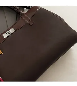 Detail view of premium dark brown vintage handbag with matte leather and silver turn-lock