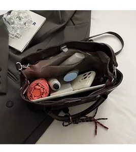 Interior view of deep brown leather tote bag showing large capacity for work essentials