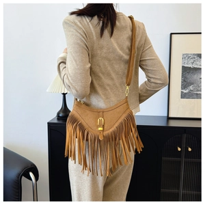 Vue détaillée du sac à bandoulière marron avec franges et boucle dorée en métal