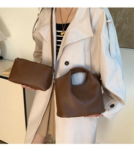 Detail of brown lychee texture leather bucket bag and small matching pouch set