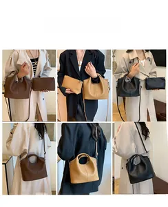 Litchi textured leather tote bag set shown in crossbody and handheld styles on a model