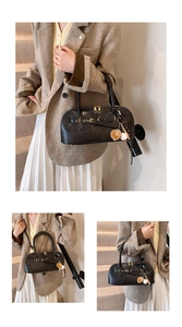 Detail view of charcoal retro leather shell bag with vintage gold hardware and charms