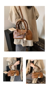 Detailed views of vintage brown shell handbag featuring leather buckle and baseball charm