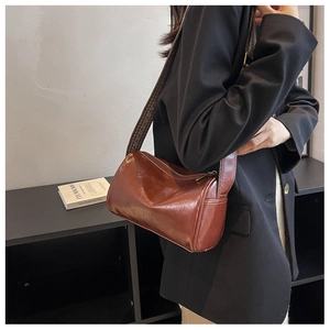 Polished brown leather bowling bag with vintage geometric woven wide shoulder strap