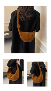 Close-up of the knotted shoulder strap and quilted suede texture on the brown croissant bag