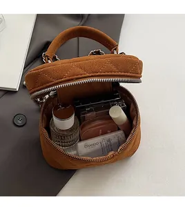 Internal view of brown quilted mini chain bag showing storage space for makeup and perfume