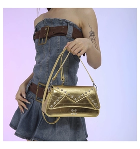 Y2K style gold metallic bag detail with silver star studs and vintage denim styling