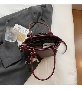 Top view of deep red bucket bag interior showing spacious capacity for phone and wallet