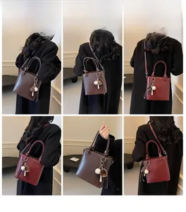 Detail view of bucket bag showing cross-body and shoulder wear options in dark brown