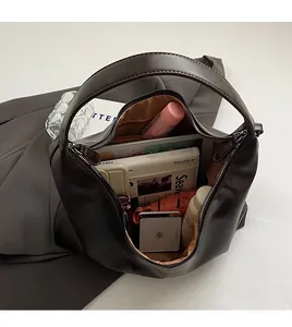 Spacious dark brown leather hobo bag showing large capacity for laptop and essentials