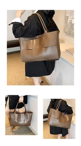 Detail of a brown woven leather tote bag showing large capacity and geometric texture