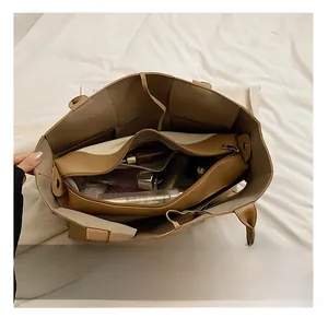 Overhead view of a large tote bag interior showing multiple storage compartments and space