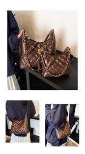 Detailed view of brown quilted saddle bags with gold chain straps and turn-lock closure