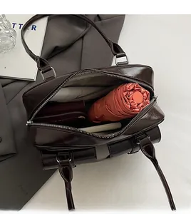 Internal view of the brown PU bowling bag showing umbrella and wallet storage