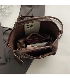 Top view of spacious brown leather bucket bag interior with a functional zipper pouch