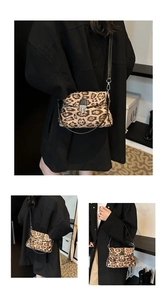 Detail of leopard print crossbody bag with silver buckle on black coat background