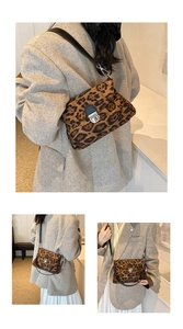Detailed view of leopard print shoulder bag with black leather strap and silver buckle