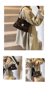 Detail view of leopard print crossbody bag featuring metal lock and black shoulder strap
