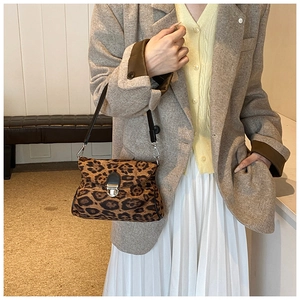 Chic leopard print crossbody bag with silver buckle worn with a grey wool blazer
