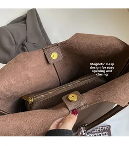 Detailed view of spacious brown bucket bag with magnetic buckle and interior zipper pocket
