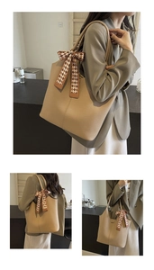 Detail of khaki large tote bag featuring lychee texture leather and checkered silk scarf