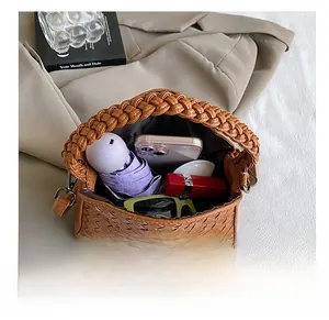 Top view of brown woven handbag interior showing large capacity for daily essentials