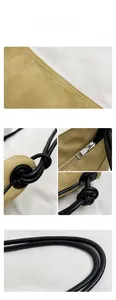 Détails du sac fourre-tout en daim kaki avec poignées nouées noires et fermeture éclair