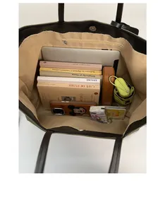 Interior view of tote bag showing large capacity for laptop, books, and umbrella
