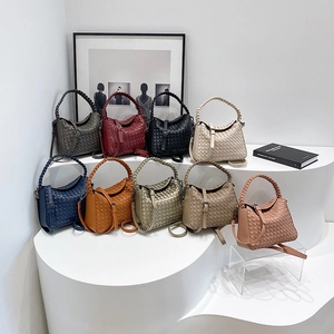 Handwoven leather crossbody handbag collection in various colors with woven handles