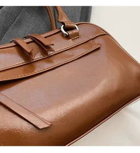Close-up of brown vintage glossy PU leather with silver metal ring and texture details