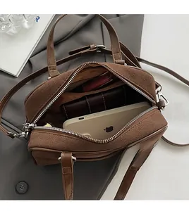 Detailed view of the spacious interior of this brown suede Boston style handbag
