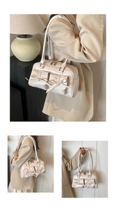 Macro shot of cream bow details and silver zipper on glossy faux leather bowling bag