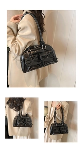 Detail of black glossy PU leather bowling bag with bow pockets and silver hardware