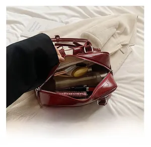 Detailed interior of the deep red shiny PU leather bowling bag with large storage capacity