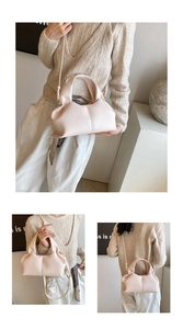 Detailed view of pale pink pleated cloud bag with textured leather and adjustable strap
