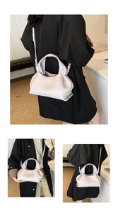 Detail of light pink dumpling bag featuring lychee grain leather and pleated textures