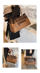 Detail of vintage caramel tote bag with faux suede texture and leather trim on luggage