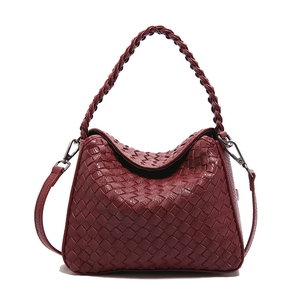 Handwoven burgundy leather tote bag with classic lattice texture and crossbody strap