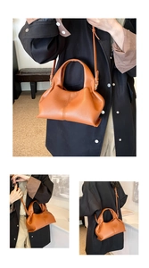 Detail of caramel pleated faux leather handbag with adjustable strap and gold hardware
