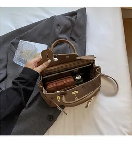 Top view showing spacious interior capacity of dark brown leather handbag with essentials