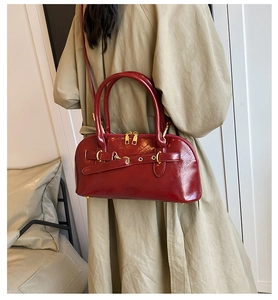 Glänzende rote Retro-Muscheltasche mit goldenen Details zu einem beigen Trenchcoat