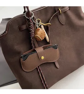 Brown litchi grain glasses pouch with woven strap and baseball glove charm on tote bag